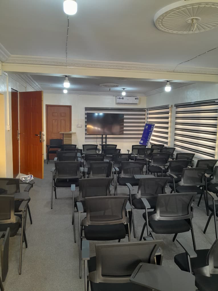The lecture hall at Minaret Talent Academy, fitted with seating and a large display